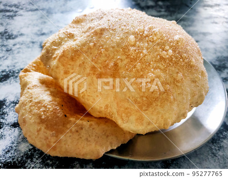 Indian street food called chole bhature at restaurant in delhi 95277765