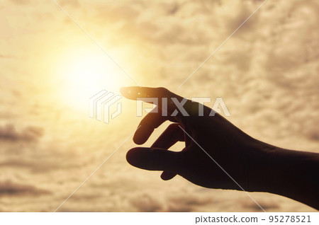 Hand reaching out to bright shining light. Hand reaching out to bright shining light. 95278521