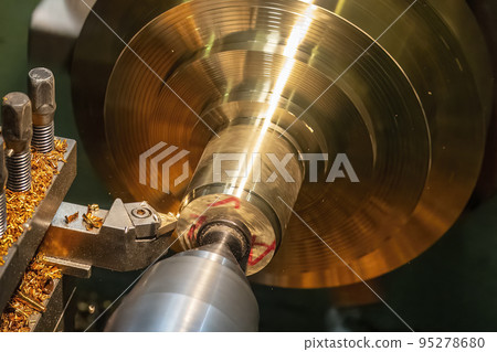Closeup scene the lathe machine rough cut the brass parts by lathe tools. Closeup scene the lathe machine rough cut the brass parts by lathe tools. 95278680