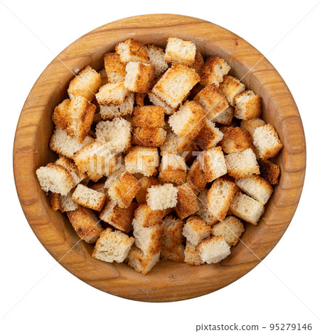 Bread rusks. Fried pieces of bread in a wooden bowl isolated on white background. Bread rusks. Fried pieces of bread in a wooden bowl isolated on white background. 95279146