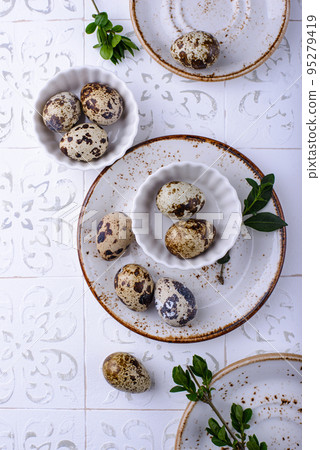 Bowl with quail eggs on light background Bowl with quail eggs on light background 95279419
