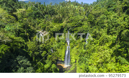 Beautiful tropical waterfall Bali Indonesia in forest at sunny day aerial view 95279573