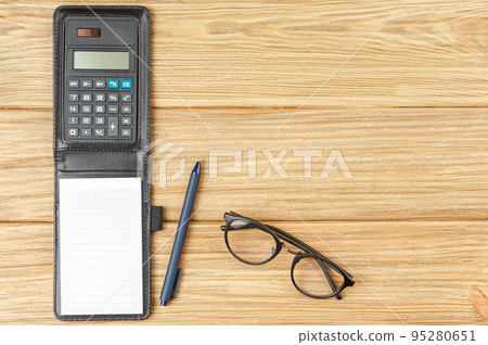 Calculator with notepad pen and glasses. Calculator with notepad pen and glasses. 95280651