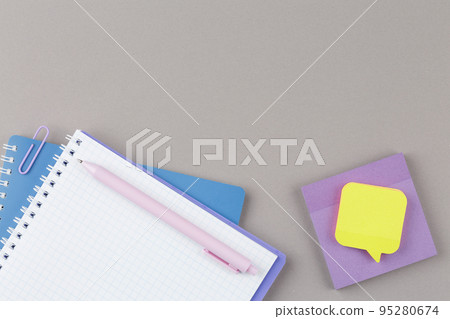 Notepad with school supplies on gray desk. Notepad with school supplies on gray desk. 95280674
