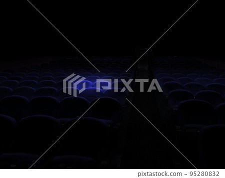 Blue seats floating in movie theater spotlights Blue seats floating in movie theater spotlights 95280832