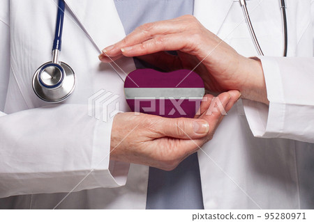 Latvian doctor holding heart with flag of Latvia background. Healthcare, charity, insurance  95280971