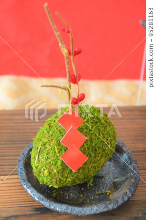 New Year decorations with red tablecloth and moss balls. Golden branches, red berries, mamezara. New Year decorations with red tablecloth and moss balls. Golden branches, red berries, mamezara. 95281163