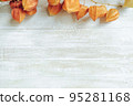 Autumn composition.Physalis border on wooden background. Flat lay 95281168