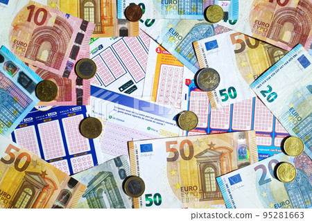 Euro coins and banknotes on the top of a stack of French lottery tickets 95281663