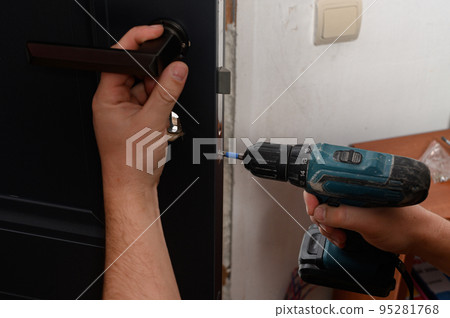 Installation of a door handle on interior doors, carpentry work with doors. 95281768