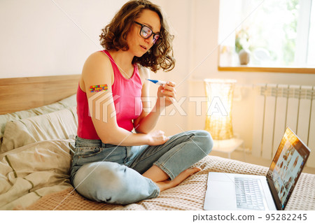 Woman blogger videotapes her vlog at home and speaking about Vaccine for covid-19. 95282245