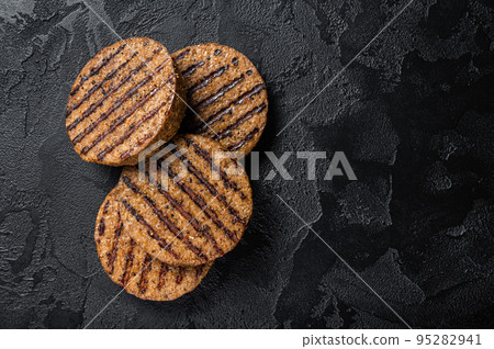 Griiled meat free patties, plant based meat steak cutlets. Black background. Top view. Copy space Griiled meat free patties, plant based meat steak cutlets. Black background. Top view. Copy space 95282941