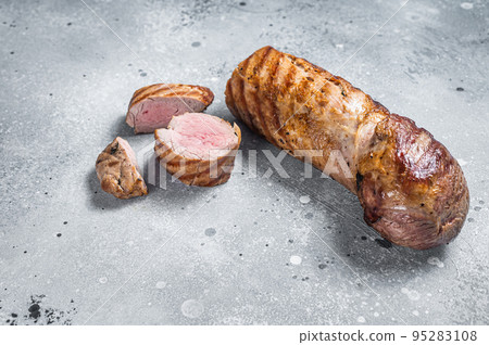 BBQ roasted pork tenderloin fillet meat. Gray background. Top view. Copy space BBQ roasted pork tenderloin fillet meat. Gray background. Top view. Copy space 95283108