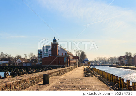 Old brick lighthouse at the Wieprza river mouth to the Baltic Sea in Darlowko, Poland Old brick lighthouse at the Wieprza river mouth to the Baltic Sea in Darlowko, Poland 95284725