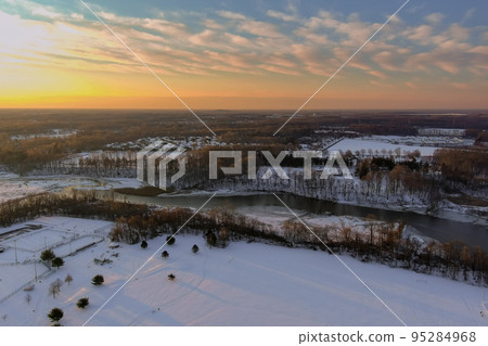 American town home complex near small river residential streets after snowfall in snowy winter landscape American town home complex near small river residential streets after snowfall in snowy winter landscape 95284968