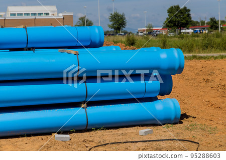 On construction site for new house, blue plastic PVS pipes were introduced to drainage of septic system to home On construction site for new house, blue plastic PVS pipes were introduced to drainage of septic system to home 95288603