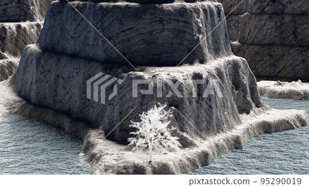 A single white tree standing on the surface of the water and a rocky mountain 95290019