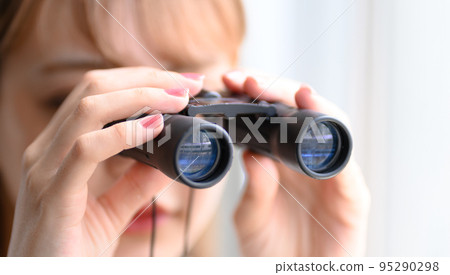 通過雙筒望遠鏡向外看的女人 通過雙筒望遠鏡向外看的女人 95290298