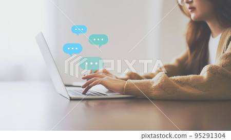 Woman using computer laptop on wood desk Woman using computer laptop on wood desk 95291304
