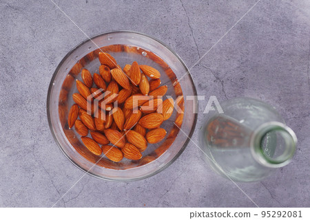 almond nuts and water in a bowl almond nuts and water in a bowl 95292081
