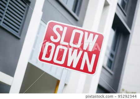 slow down sign against a building slow down sign against a building 95292344