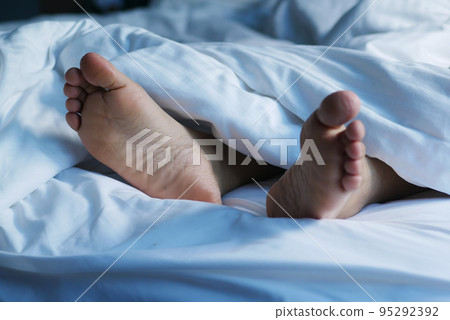 woman feet on the white bed  95292392