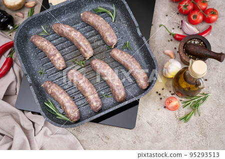 Grilled sausages on a grill frying pan on a domestic kitchen Grilled sausages on a grill frying pan on a domestic kitchen 95293513