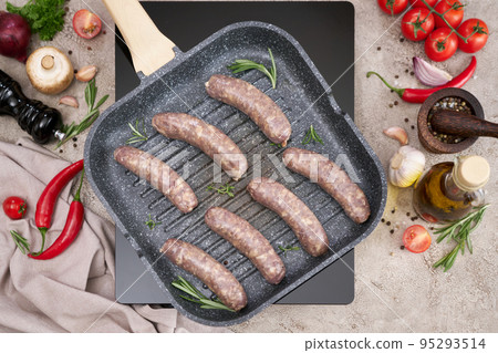 Grilled sausages on a grill frying pan on a domestic kitchen Grilled sausages on a grill frying pan on a domestic kitchen 95293514