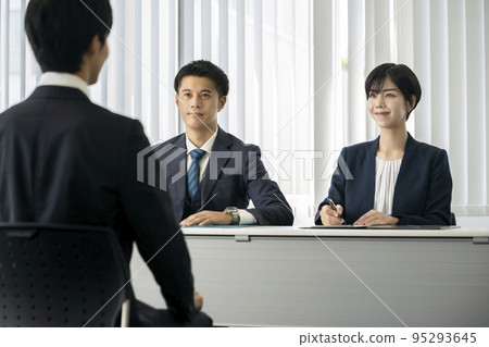 Interview job hunting image Two interviewers, a man and a woman, face students Interview job hunting image Two interviewers, a man and a woman, face students 95293645