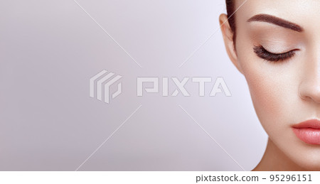 Female eye with long false eyelashes Female eye with long false eyelashes 95296151