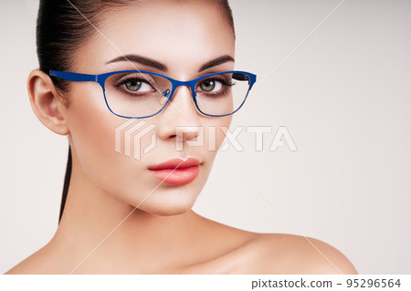 Woman with long eyelashes in eyeglasses Woman with long eyelashes in eyeglasses 95296564