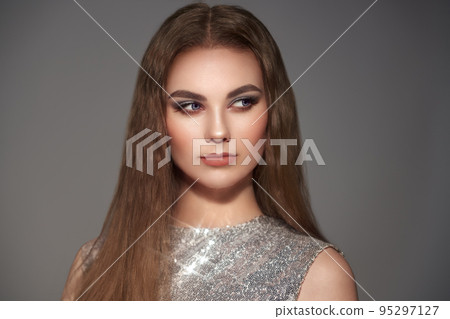 Brown-haired woman with long smooth hair Brown-haired woman with long smooth hair 95297127