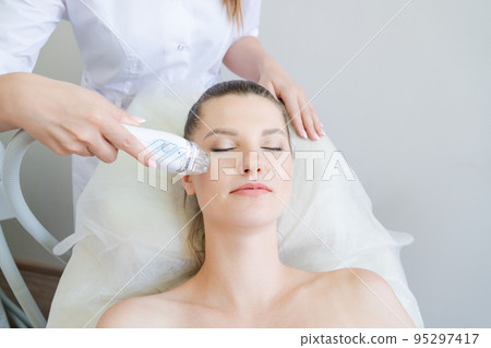 Gorgeous woman in beauty clinic receives non-surgical face lift. SMAS 95297417
