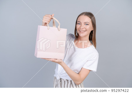 Young cheerful woman happy positive smile, hold bag package, buy customer sale Young cheerful woman happy positive smile, hold bag package, buy customer sale 95297422