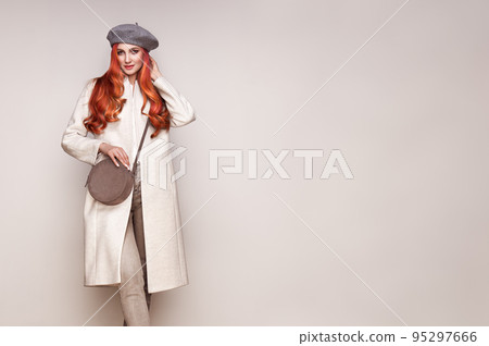 Young woman in white autumn coat Young woman in white autumn coat 95297666