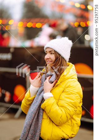 Happy woman ice skating on the ice arena in the city square on Festive Christmas fair. Cold weather. Happy woman ice skating on the ice arena in the city square on Festive Christmas fair. Cold weather. 95297758