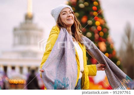 Happy woman ice skating on the ice arena in the city square on Festive Christmas fair. Cold weather. Happy woman ice skating on the ice arena in the city square on Festive Christmas fair. Cold weather. 95297761