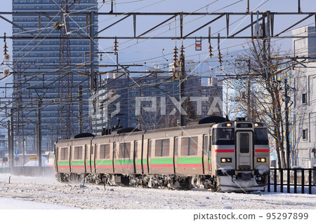 A local train on the Hakodate Main Line running near Naebo Station in winter 95297899