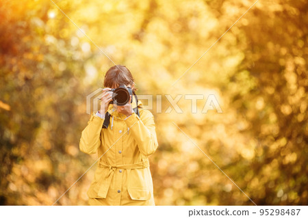 Young Pretty Caucasian Happy Smiling Girl Woman On Road In Autumn Forest. Tourist Woman Walking And Taking Photos In Forest. Fun Enjoy Outdoor Autumn Nature. Lady Photographed Nature 95298487