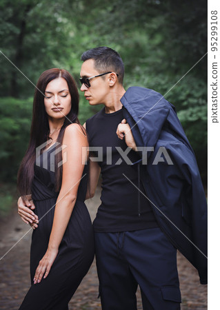 Portrait of a young couple in dark clothes Portrait of a young couple in dark clothes 95299108