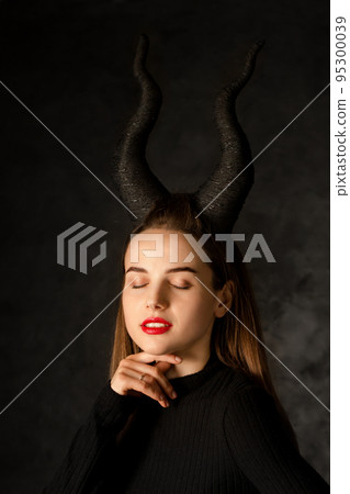 beautiful woman with long horns on a black background beautiful woman with long horns on a black background 95300039