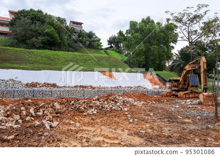 Series of slope retention construction design with rocks and mesh to manage landslide 95301086