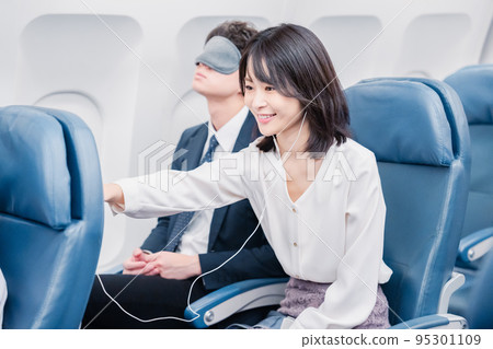 Passengers using in-flight entertainment Passengers using in-flight entertainment 95301109