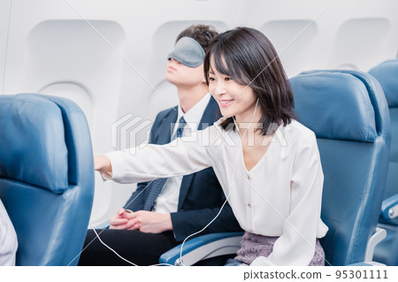 Passengers using in-flight entertainment Passengers using in-flight entertainment 95301111