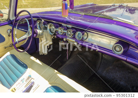 Cuba Dashboard of an old purple Pontiac with American flag in Havana Cuba Dashboard of an old purple Pontiac with American flag in Havana 95301312