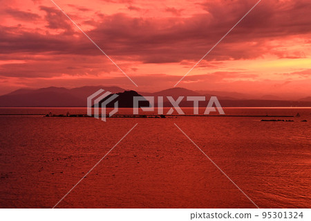 The evening view of the mysterious Chikubu Island floating in Lake Biwa in early autumn is beautiful. The evening view of the mysterious Chikubu Island floating in Lake Biwa in early autumn is beautiful. 95301324