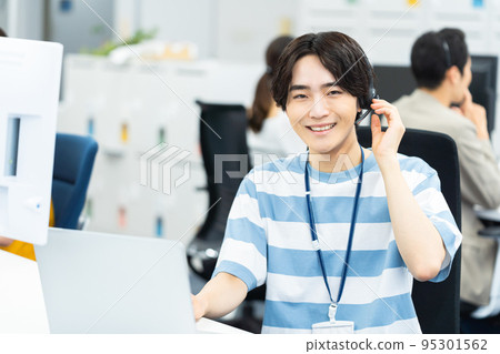 Young man working in a call center Young man working in a call center 95301562