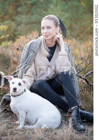 Young attractive woman playing with dog 95302682