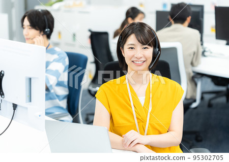 Young business woman working in a call center Young business woman working in a call center 95302705