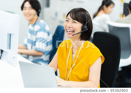 Young business woman working in a call center Young business woman working in a call center 95302903
